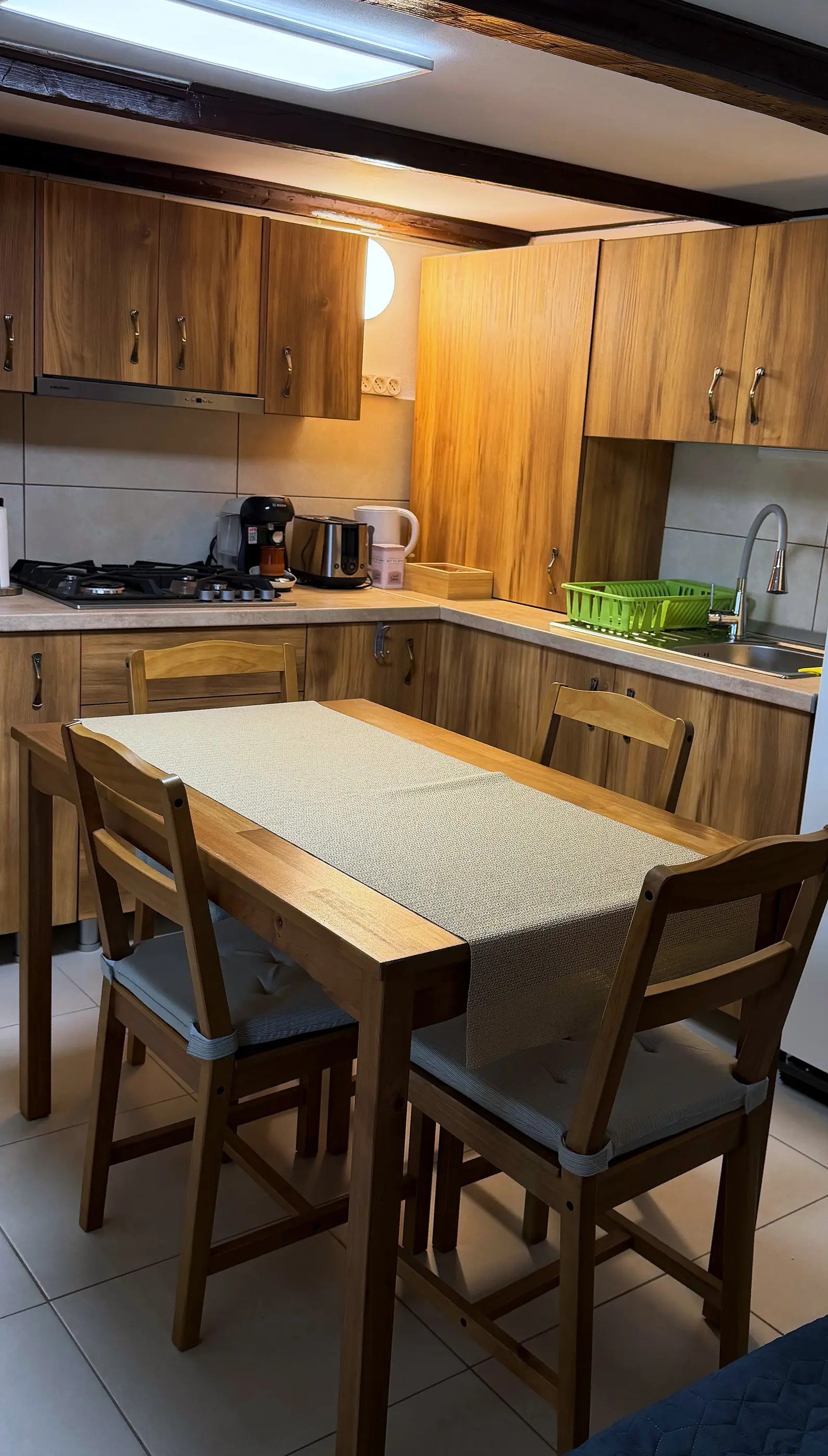 The fully equipped kitchen, with a wooden table for four