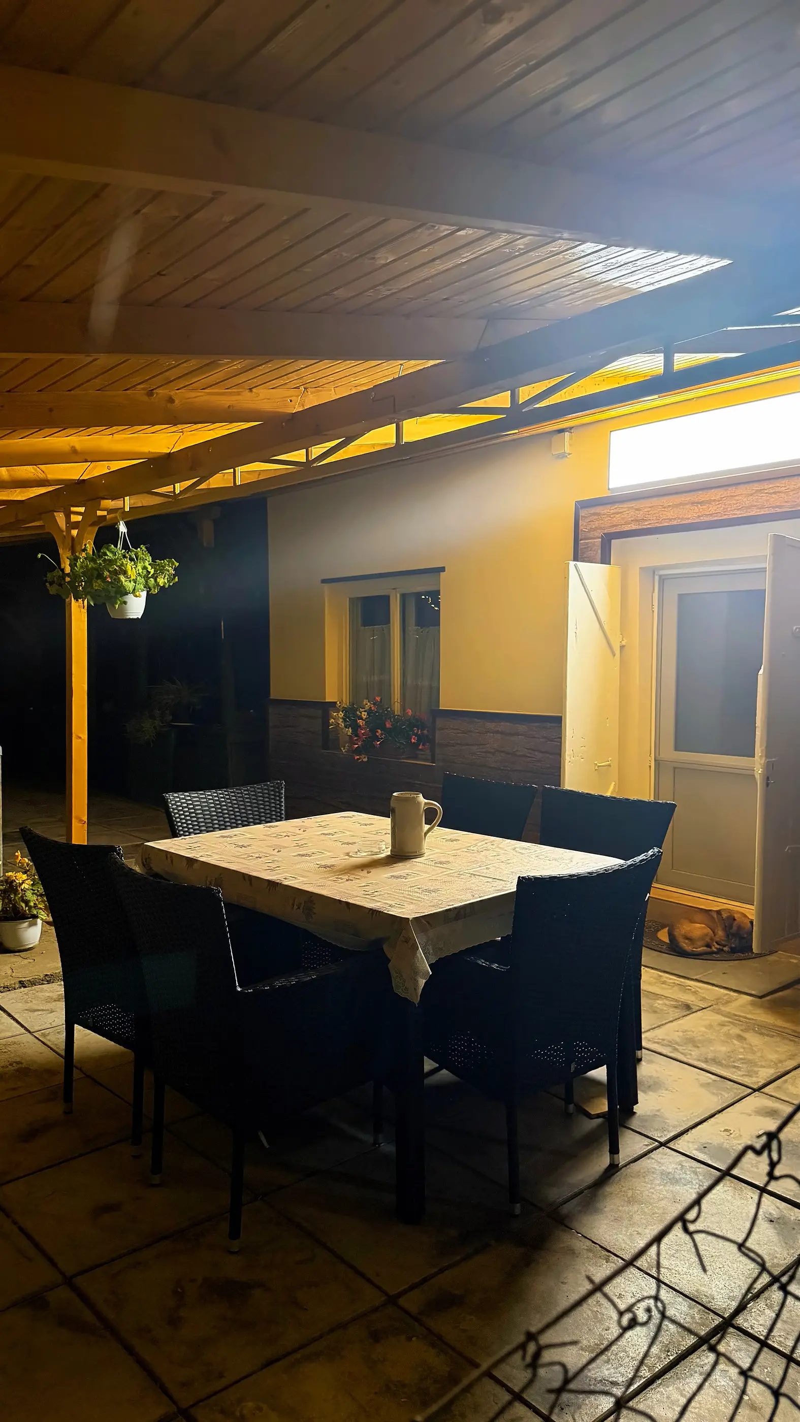 The terrace in warm light at night, in the courtyard